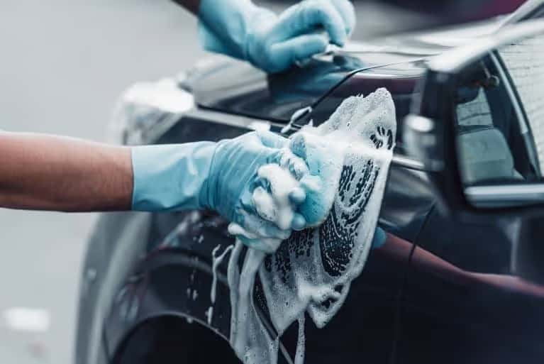 Sponge cleaning a car