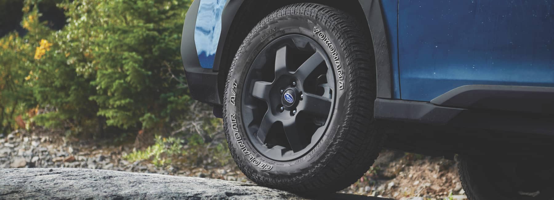 2022 Subaru Outback front wheel climbing a mountainous road