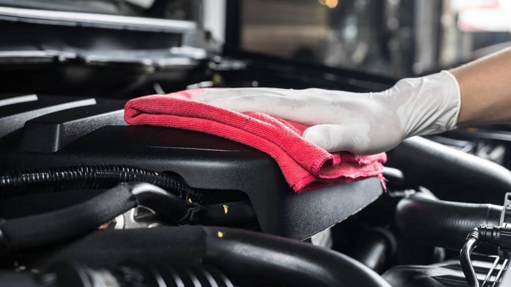 hand cleaning an engine