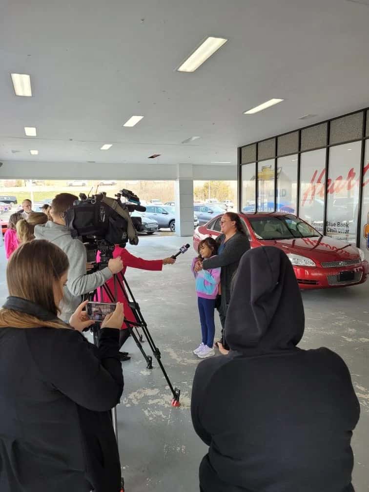 mother and daughter being interviewed in front of Heartland Chevrolet