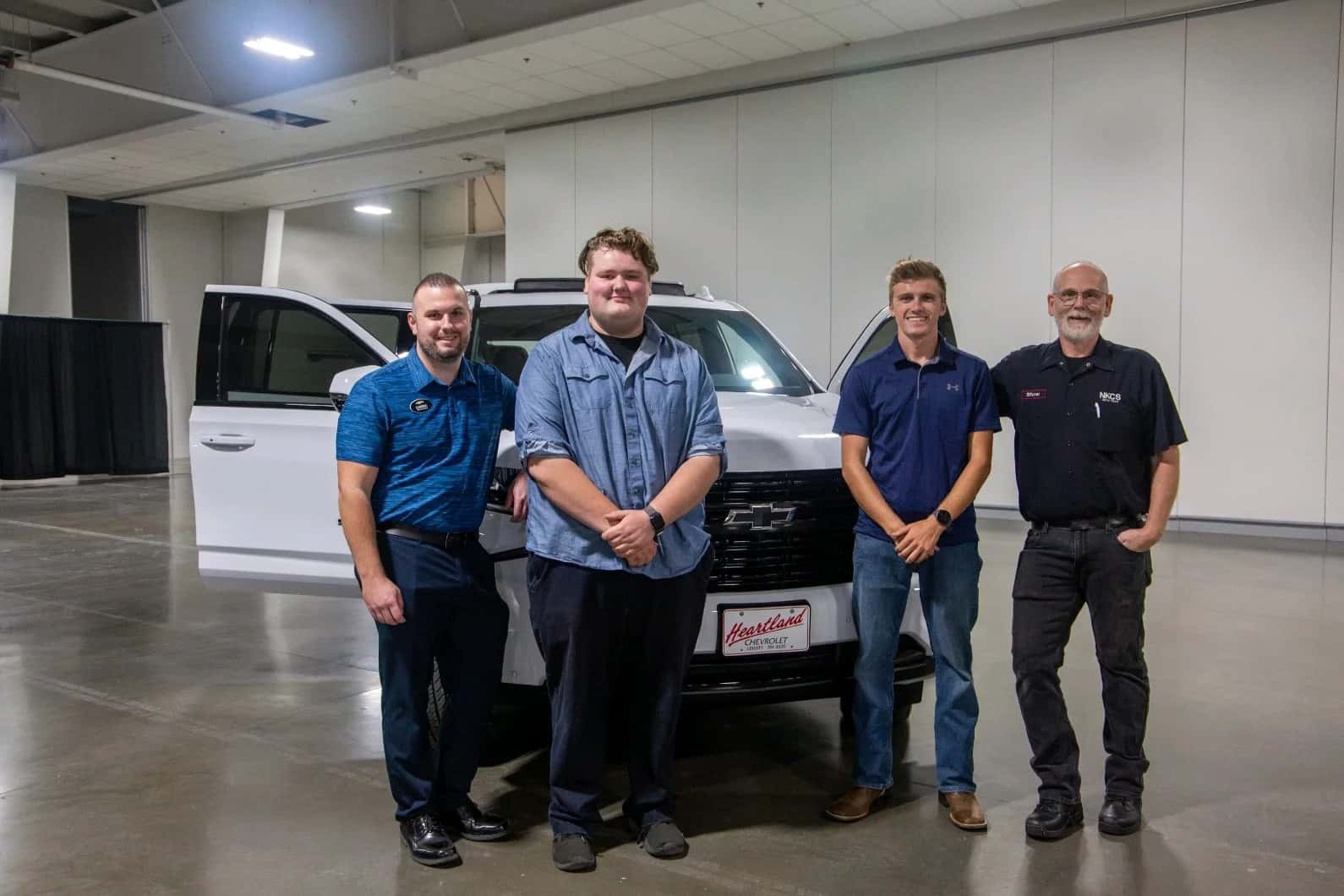 Heartland Chevrolet service technicians stand in front of vehicle