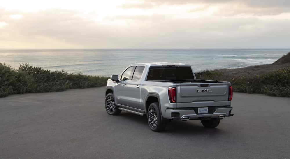 A silver 2025 GMC Sierra 1500 Denali Ultimate from the rear after leaving a GMC dealer.