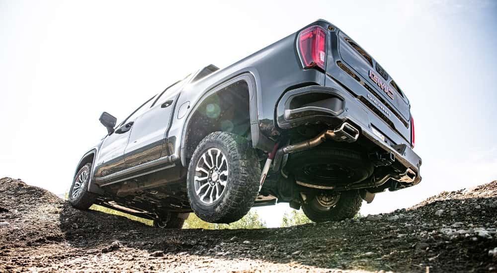 A black 2025 GMC Sierra 1500 AT4 from a low angle.