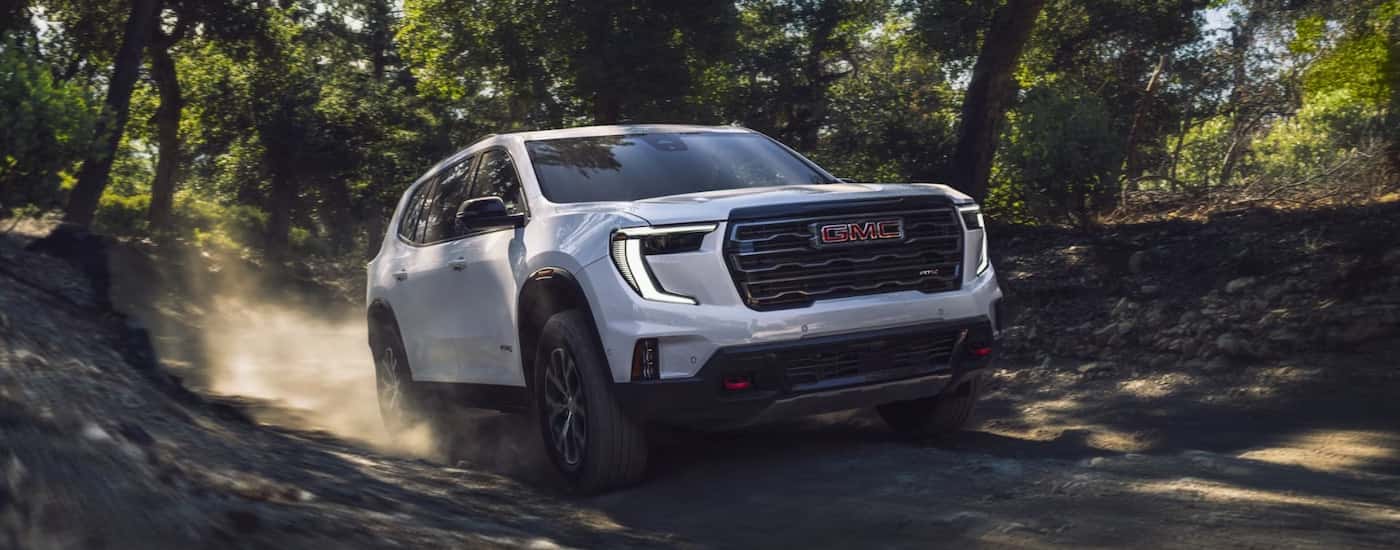 A white 2025 GMC Acadia from the front at an angle.