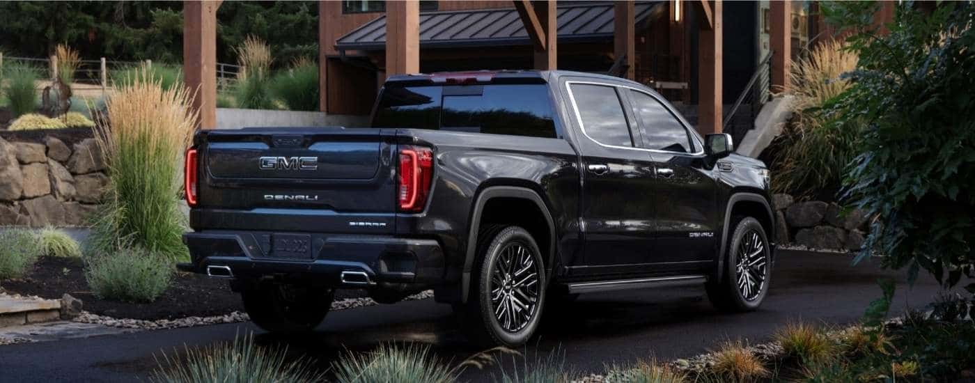 A black 2025 GMC Sierra 1500 from the rear after leaving a GMC dealer.