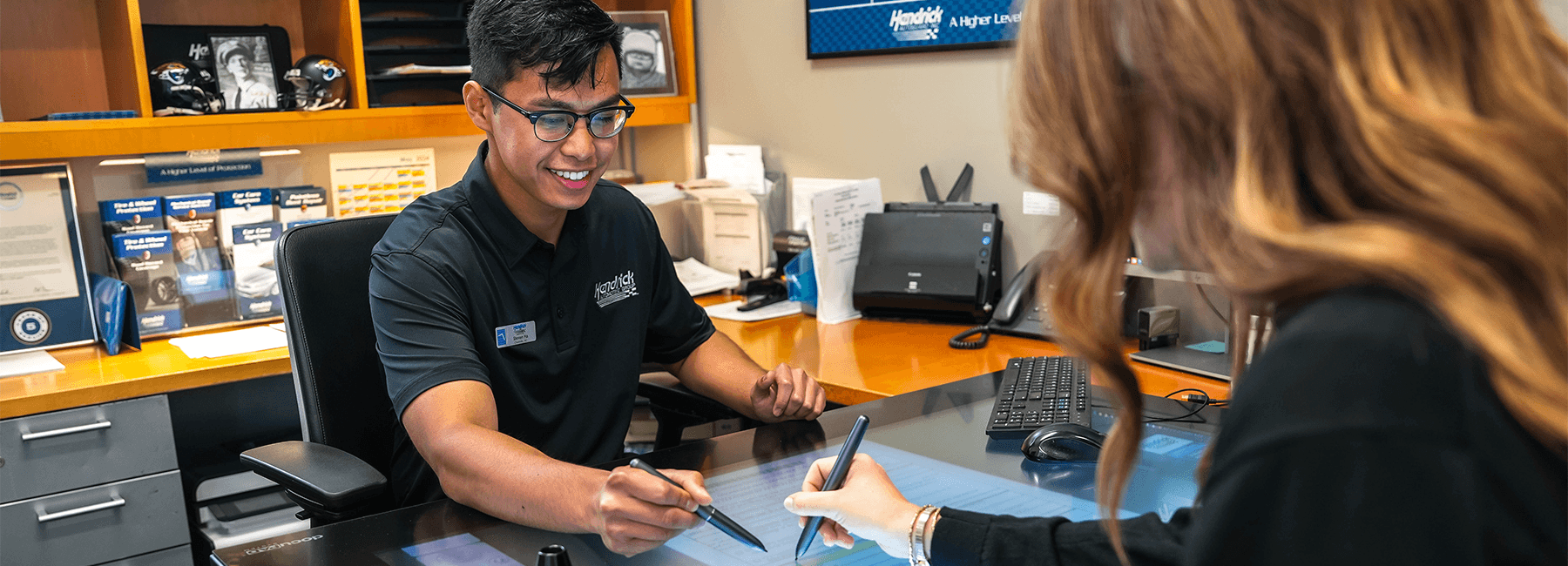 Finance specialist talking to a couple in a dealership