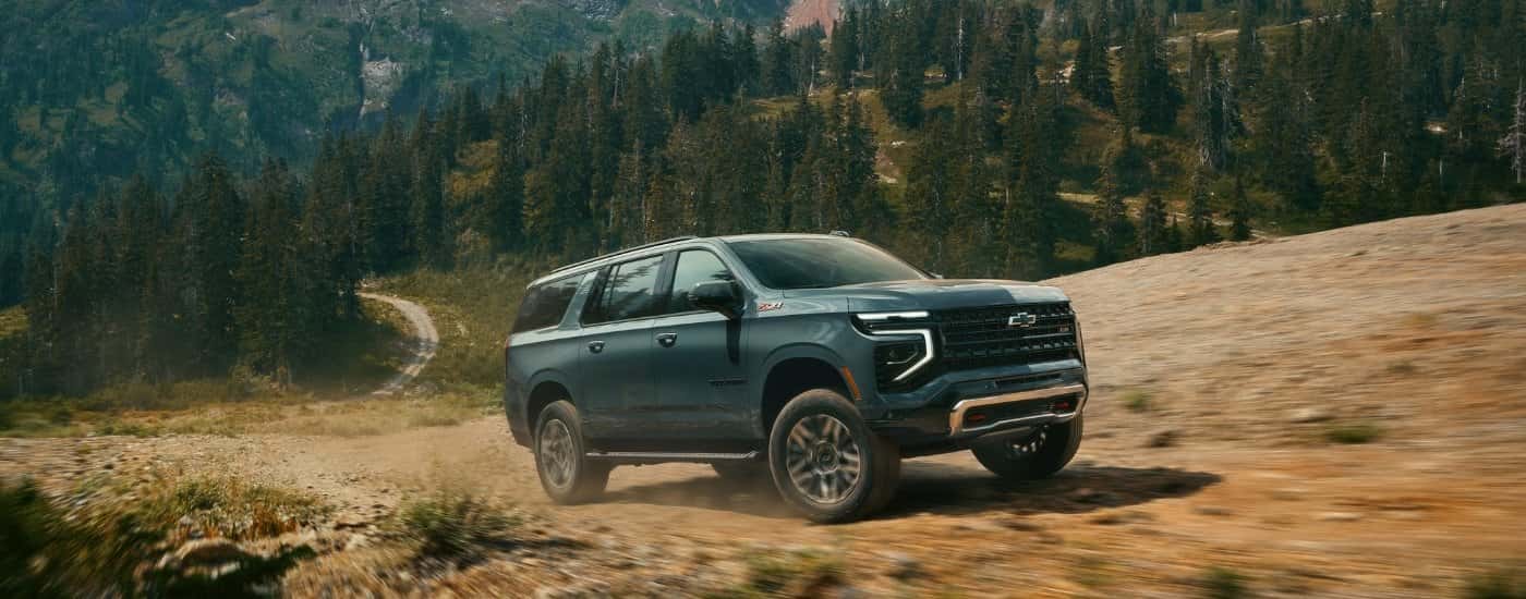 A green 2025 Chevy Suburban off-roading.