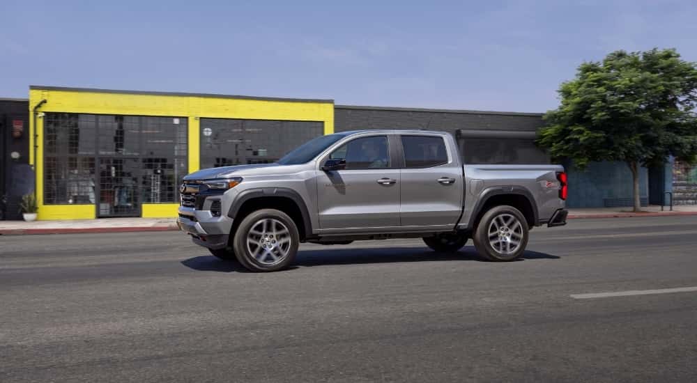A silver 2026 Chevy Colorado from the side after leaving a Chevy dealer.