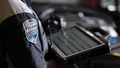 hendrick service technician under a vehicle
