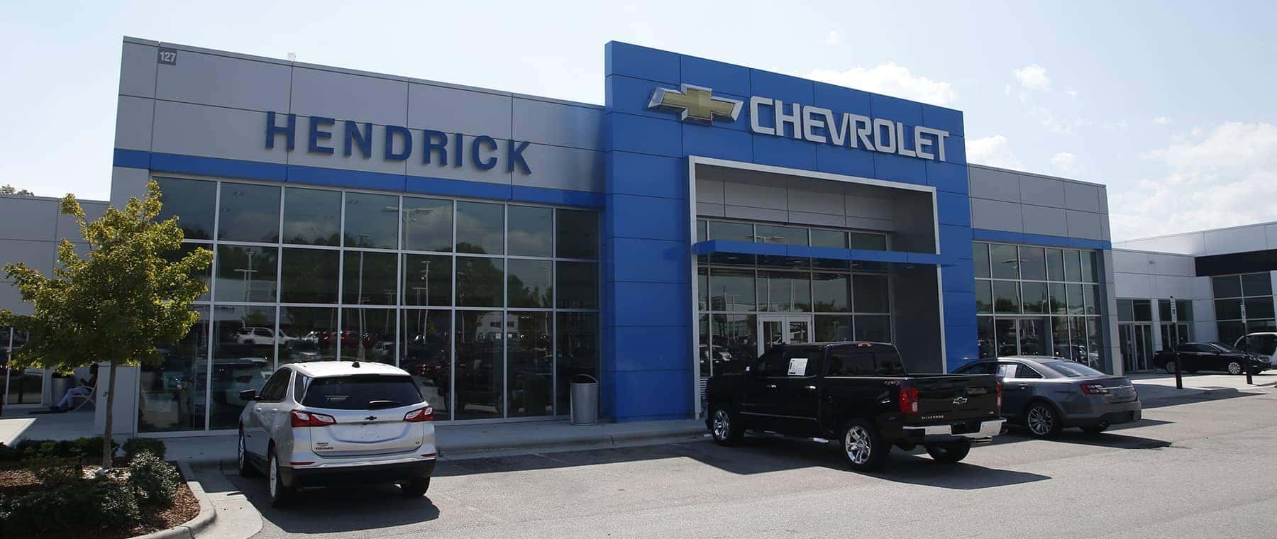 An exterior shot of a Chevrolet dealership at night.