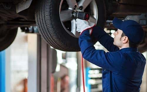 technician changing car tire