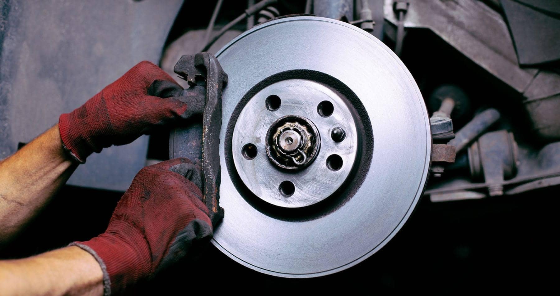 Technician installing brake pads.