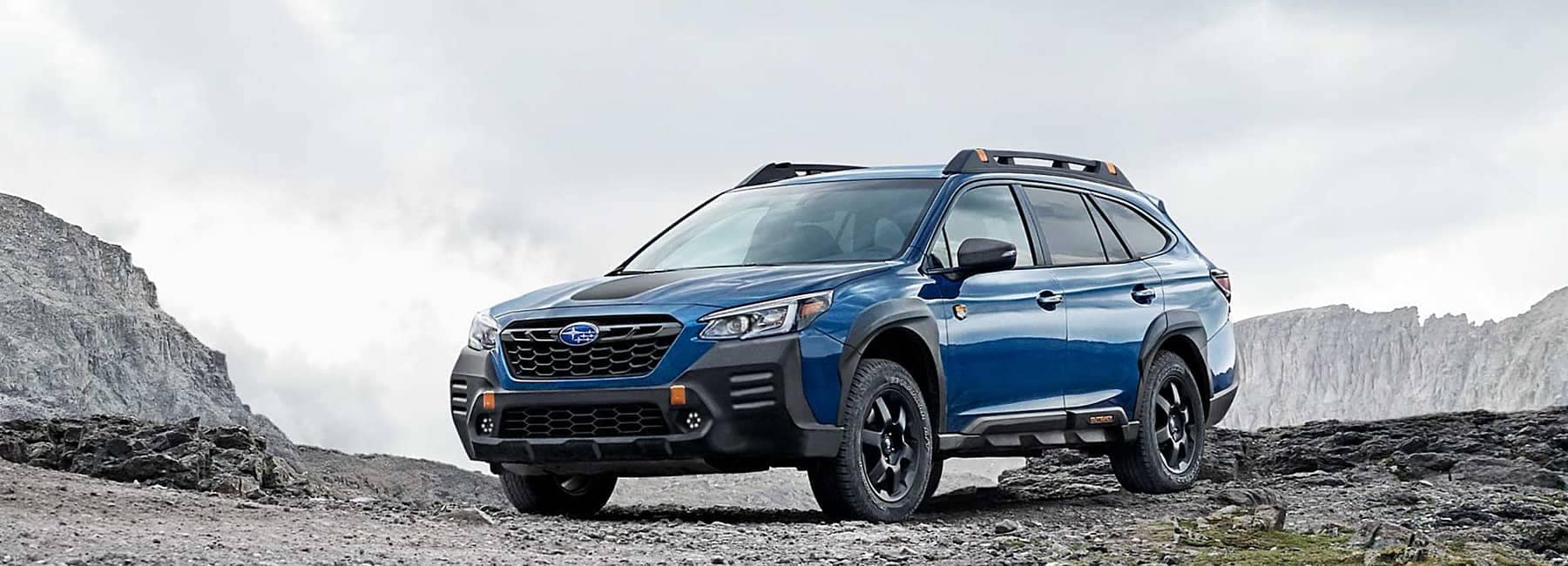 Outback- front 3qview-hero- parked in rocky surroundings-blue