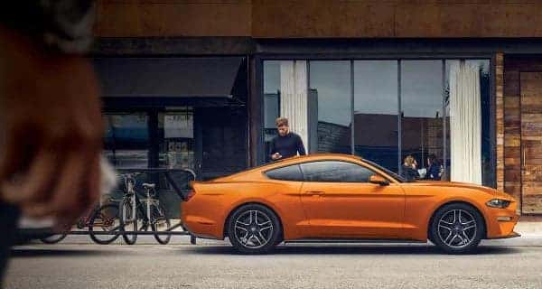 Man getting into Ford Mustang