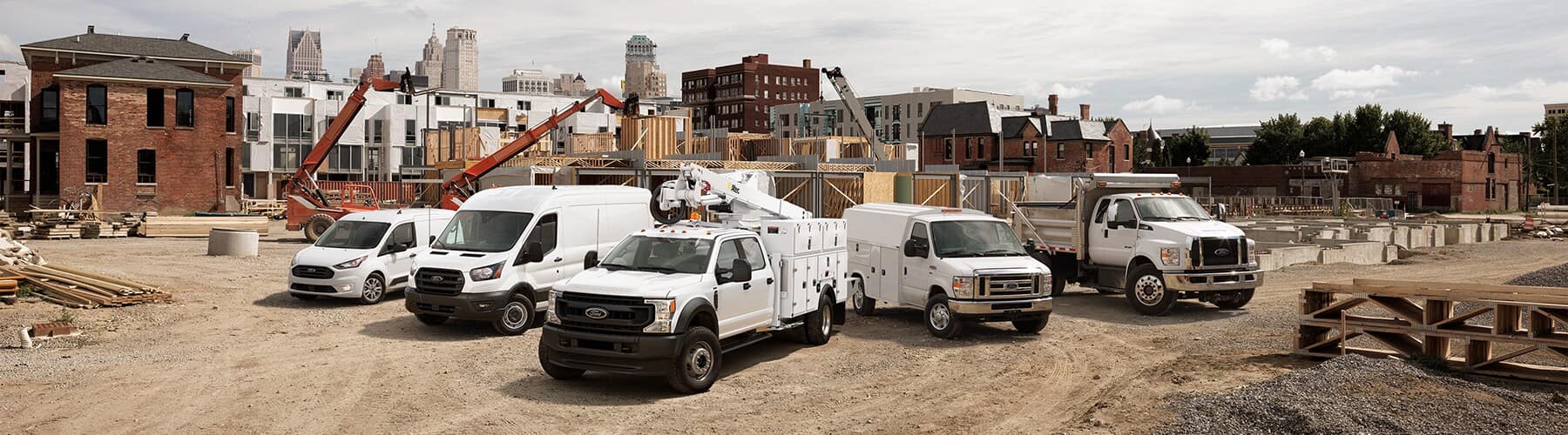 Ford commercial trucks parked in construction site