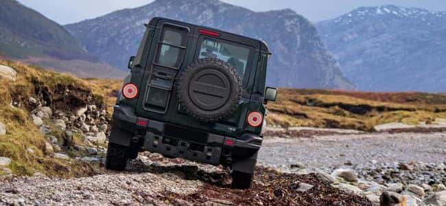 A INEOS Grenadier driving over rocky terrain