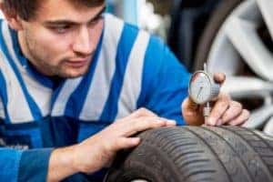 Mechanic Checking Tire Pressure