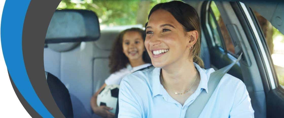 Lady smiling at her daughter in the car
