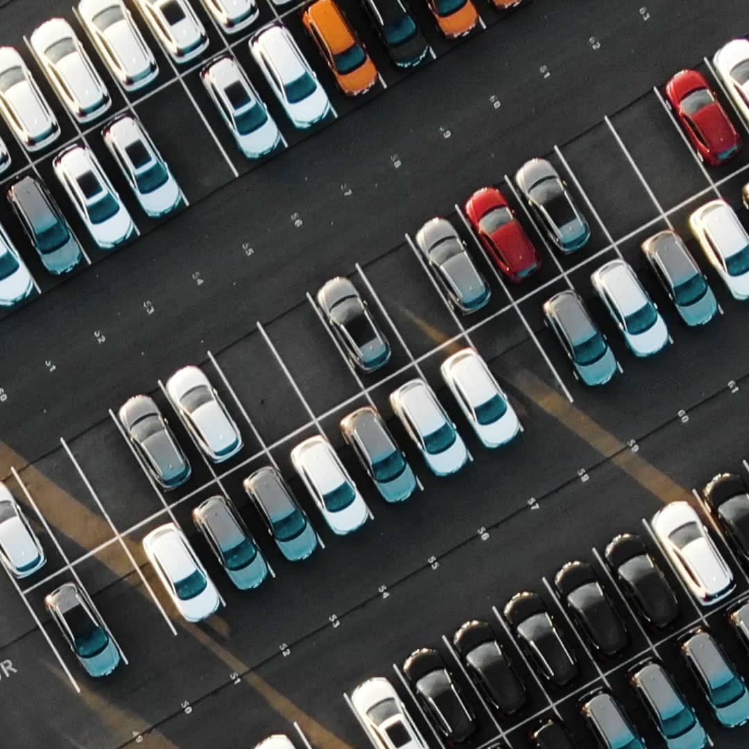 Direct overhead angled view of cars in a car lot