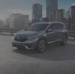 Honda SUV parked with cityscape in background