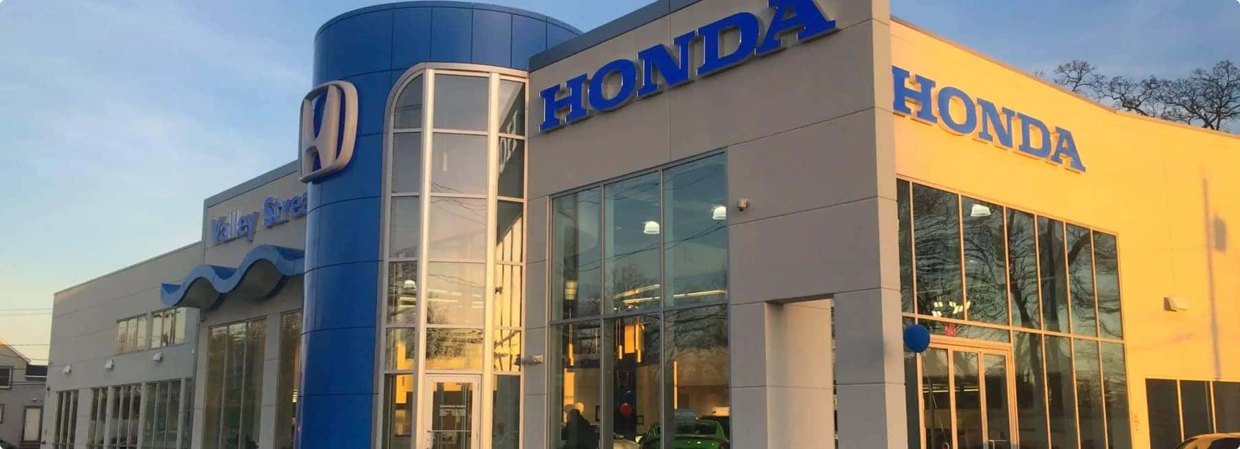 An exterior shot of a Honda dealership during the day