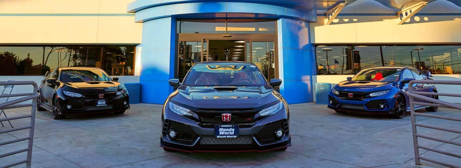 An exterior shot of a Honda dealership during the day