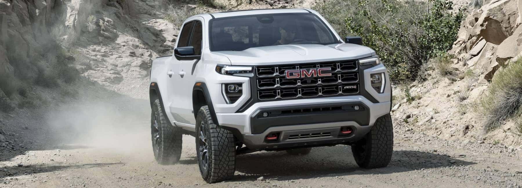 2023 GMC Canyon driving down gravel road