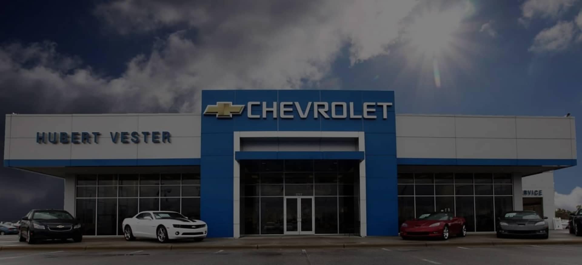 An exterior shot of a Chevrolet dealership in the day.