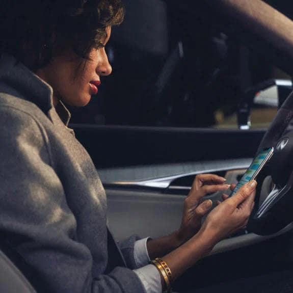 Woman in QX50 on phone