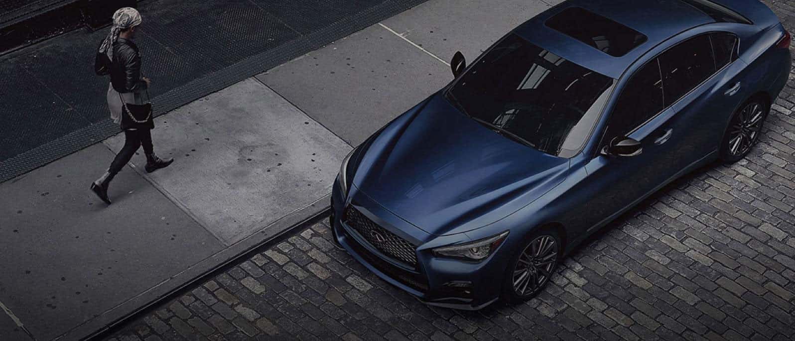 2023 Q50 Woman Walking To Car