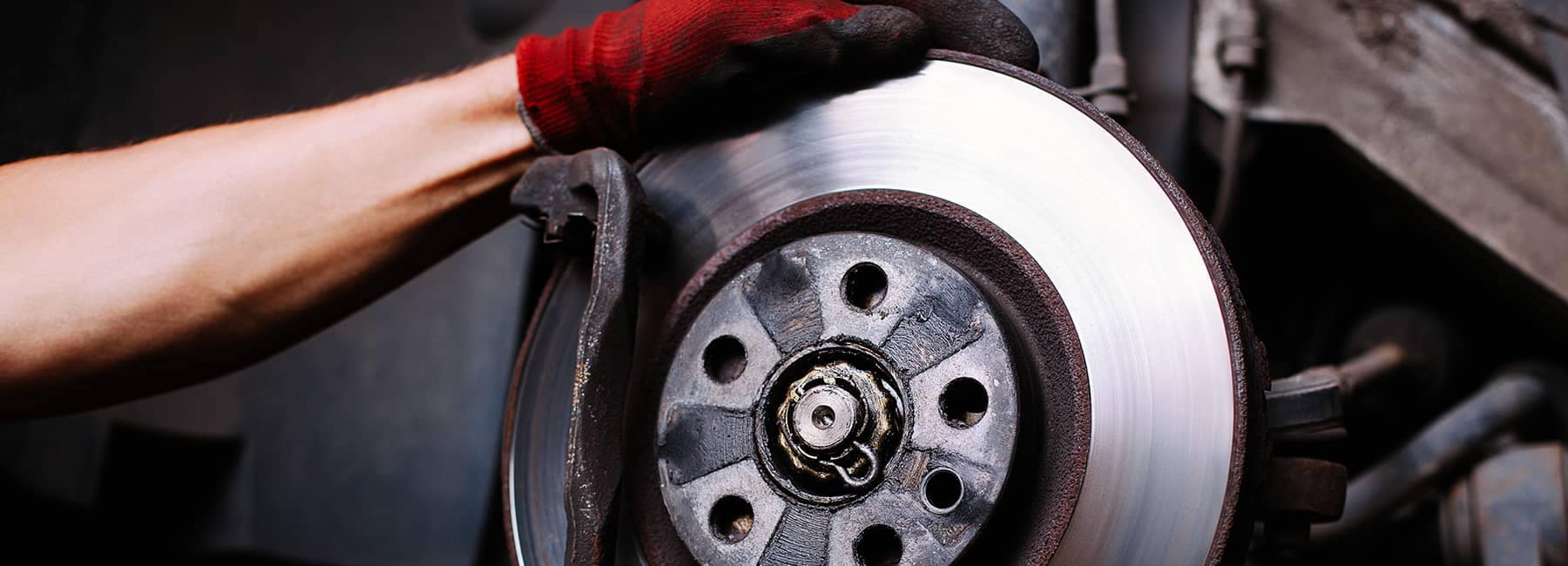 Auto mechanic performing car rotor maintenance