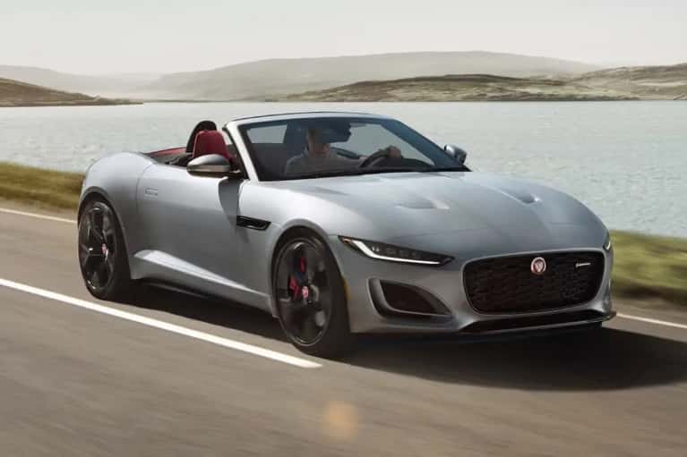 silver-jaguar-drives-along-lakeside-road