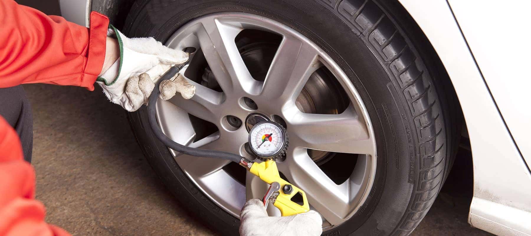 Tire picture of technician checking tire pressure