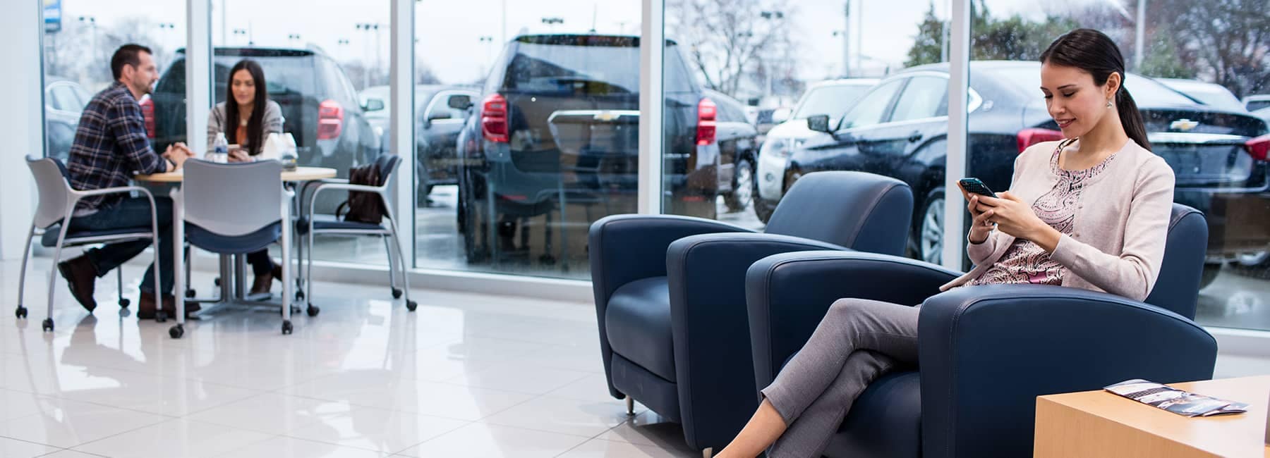 Chevrolet customers sitting in a showroom