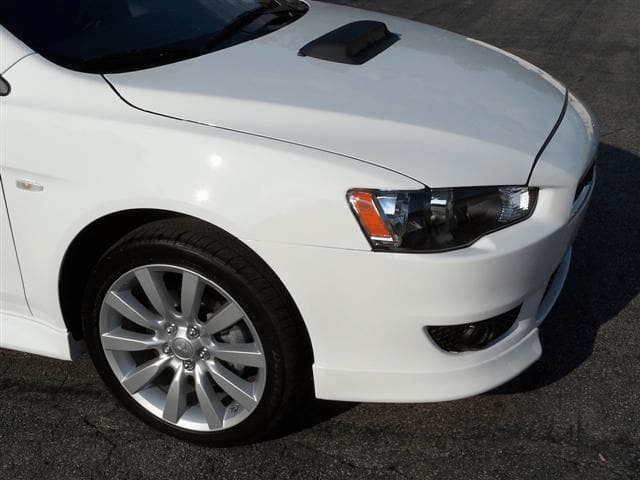 White Mitsubishi sedan after repairs
