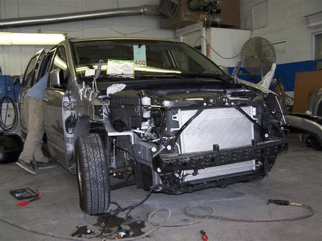 Van with the front exterior removed showing the collision repair process