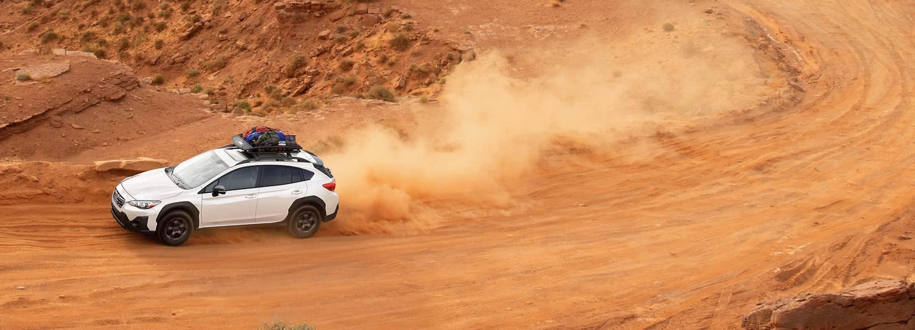 2022 Subaru Crosstrek speeding on a dusty desert road