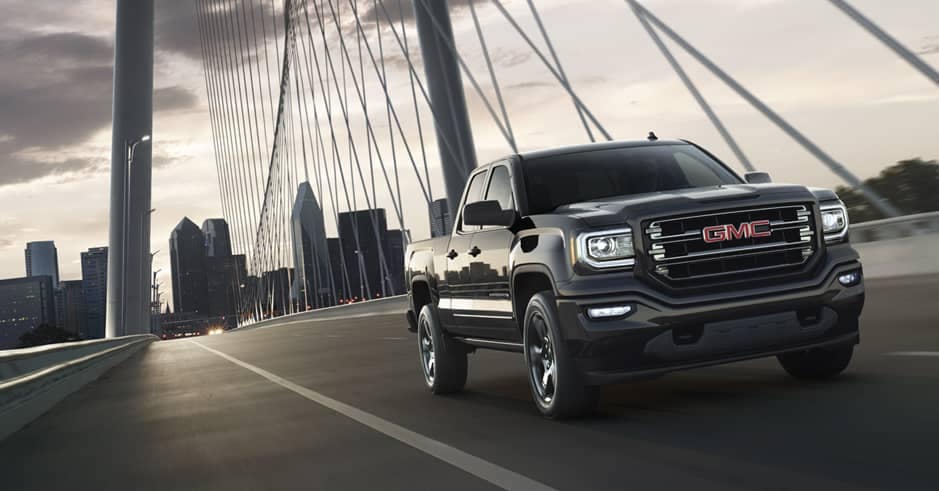 GMC Sierra Elevation Edition Driving fast over a suspension bridge in the city