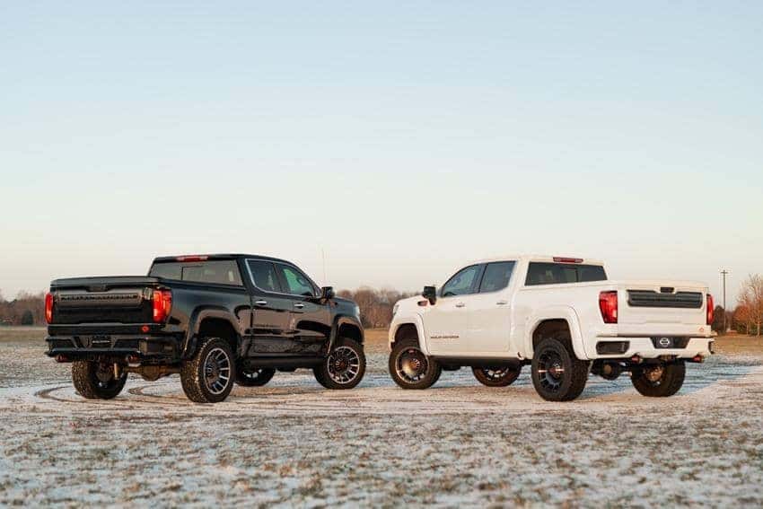 2 Harley-Davidson GMC Sierra Trucks Facing each other showing their tailgates back view
