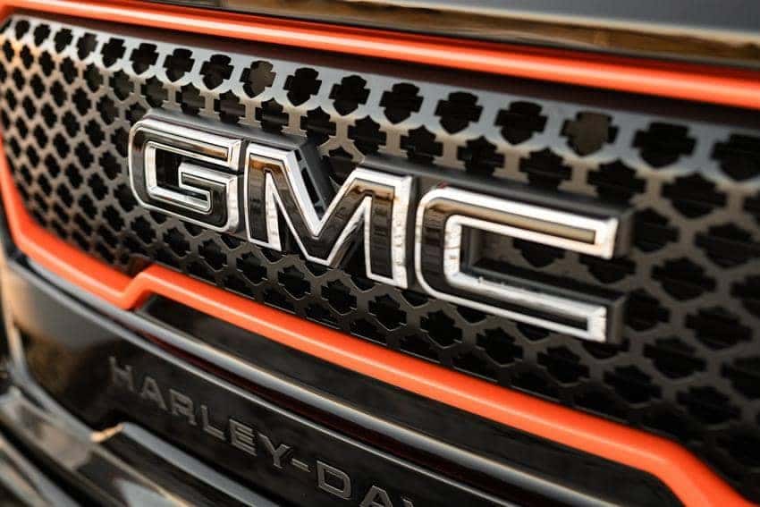 Harley-Davidson GMC Sierra White Truck Showing Harley Davidson Grille angled view from black truck