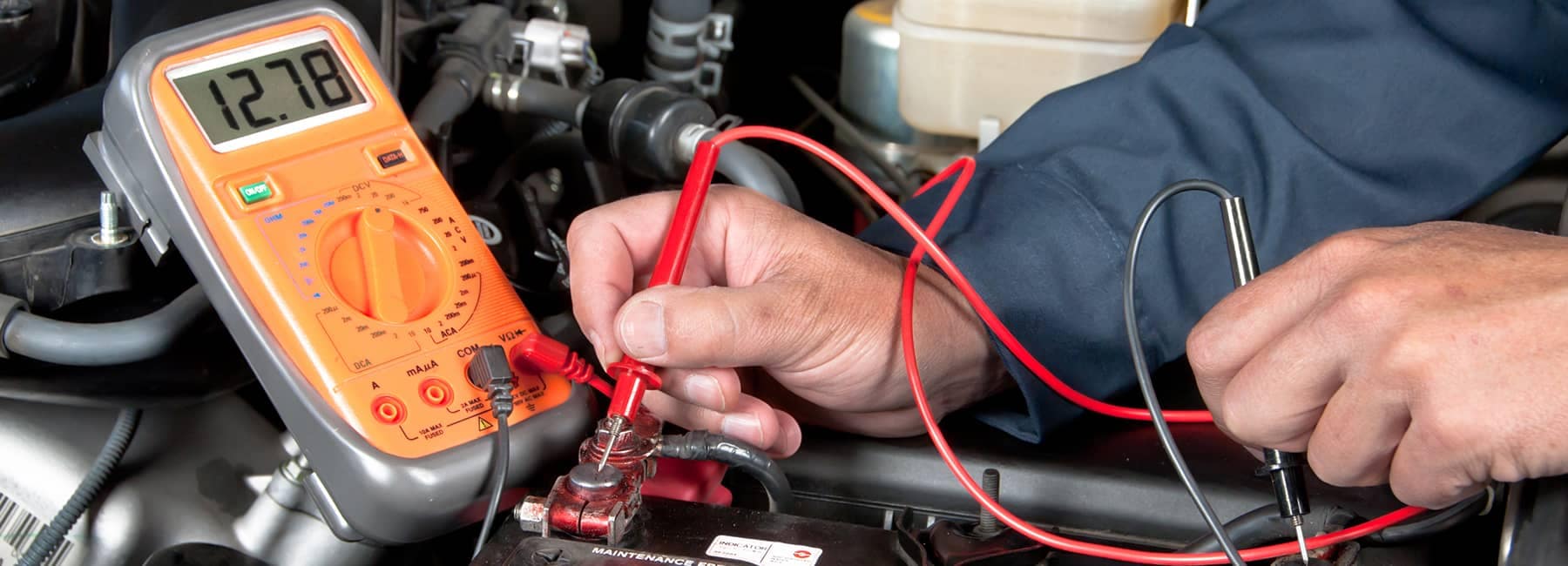 technician checks car battery power