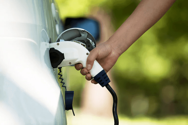 Hand holding a charger to a fuel port