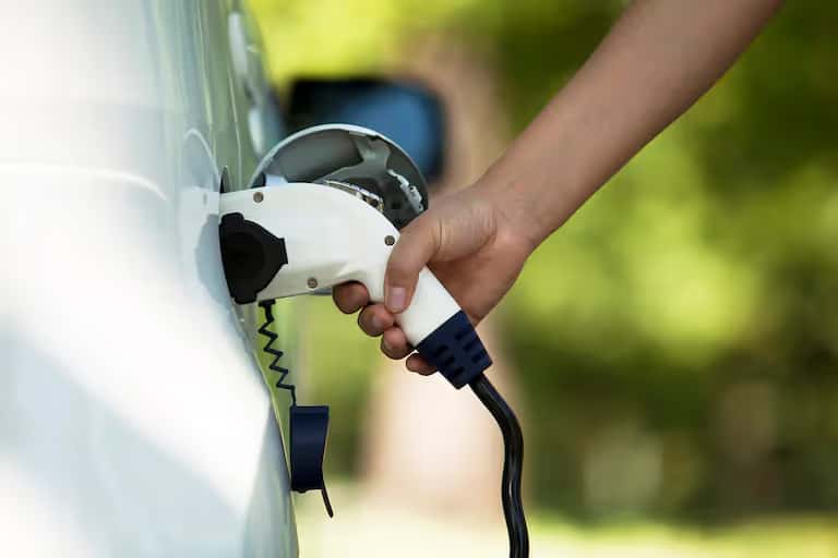 Hand holding a charger to a fuel port