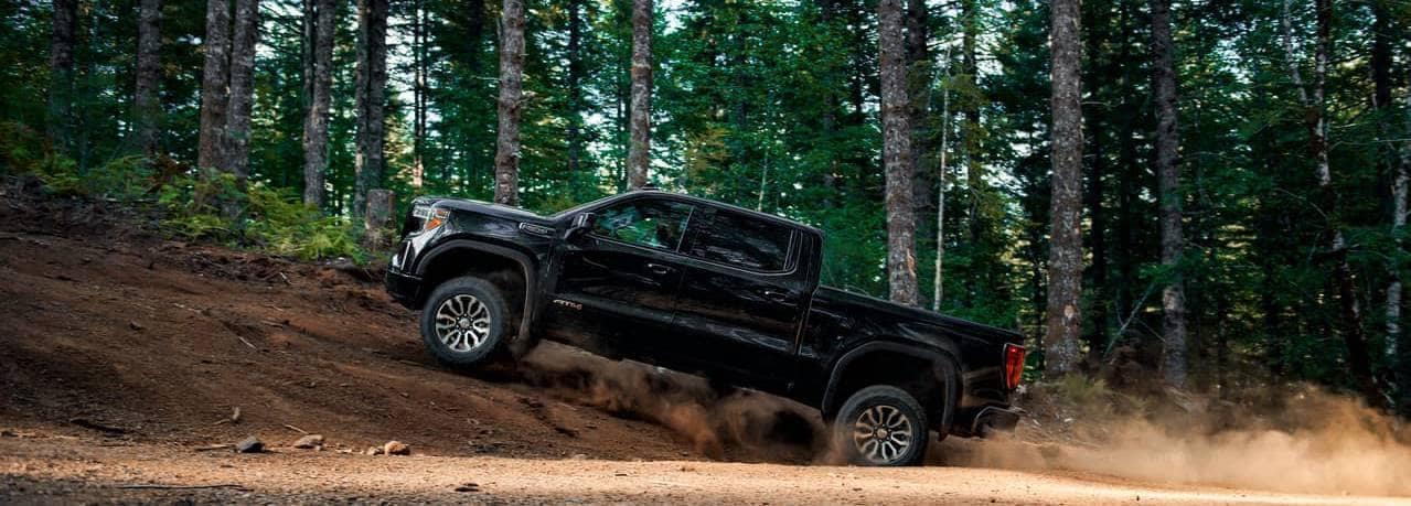 GMC Sierra 1500 AT4 driving in the forest