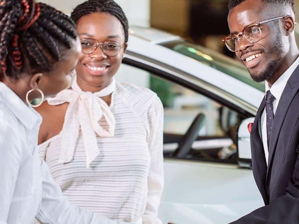 man is shaking hands with saleswoman