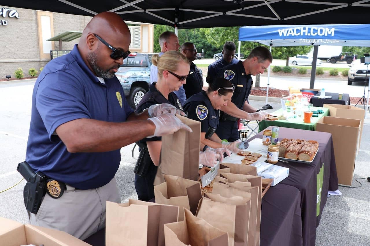 Police officers making food for brown bag lunches