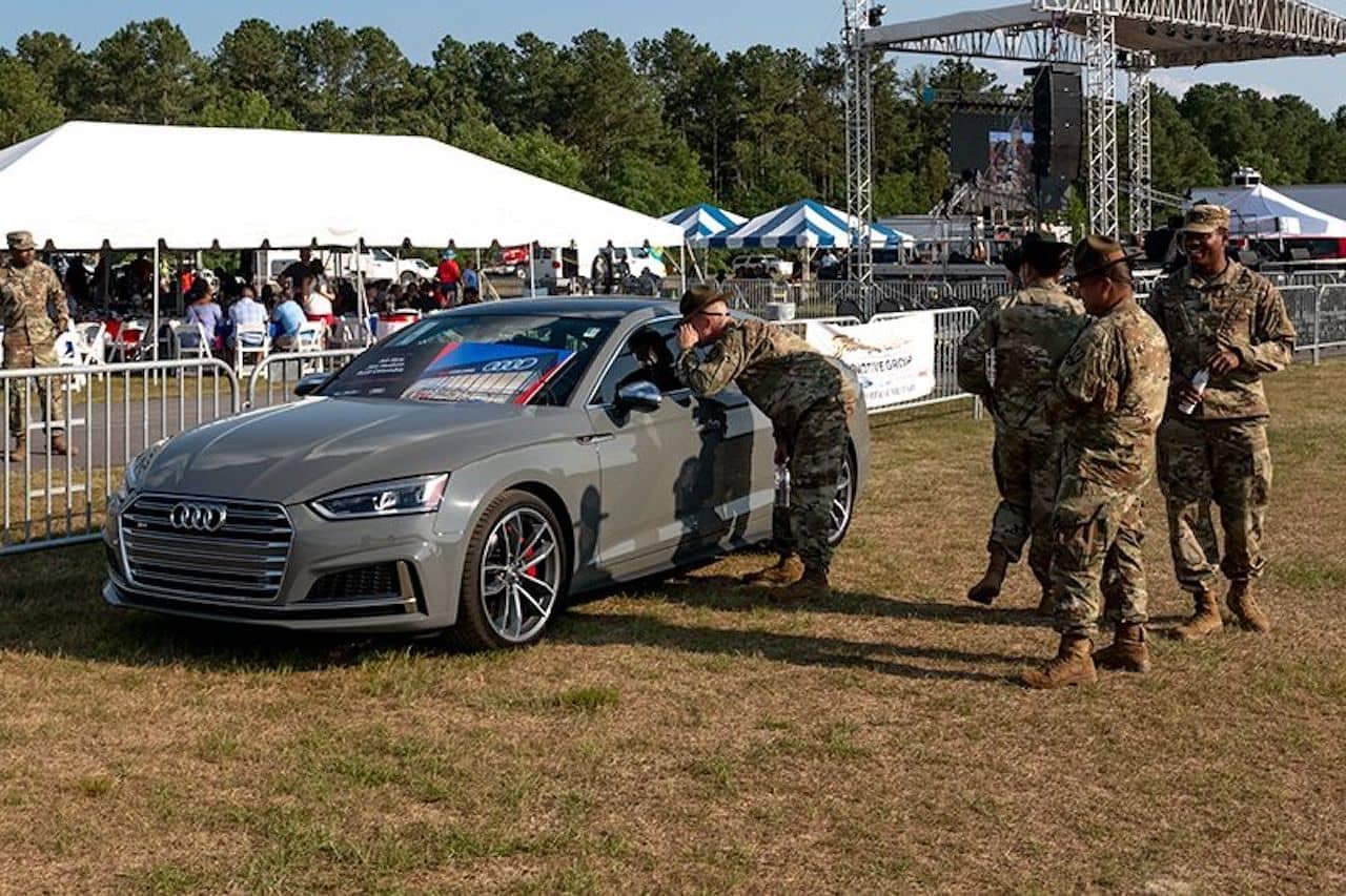 Military members looking at Audi at Jim Hudson event