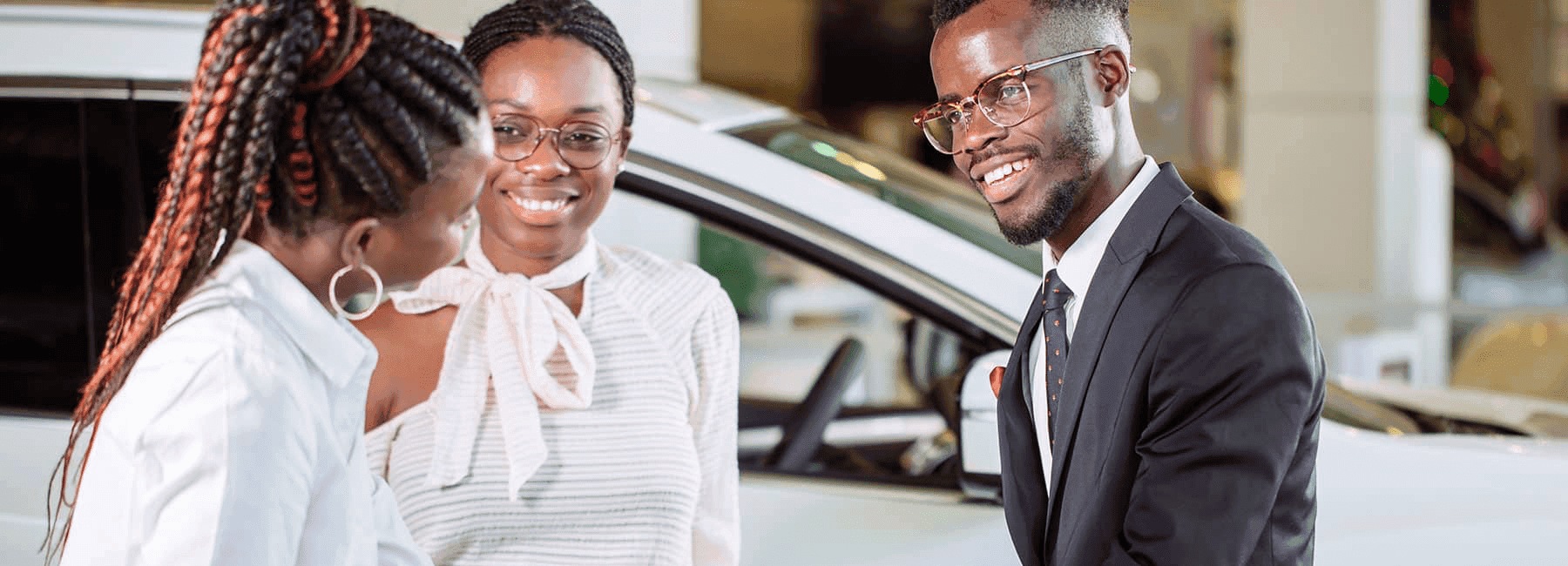 smiling-couple-with-salewoman-in-showroom