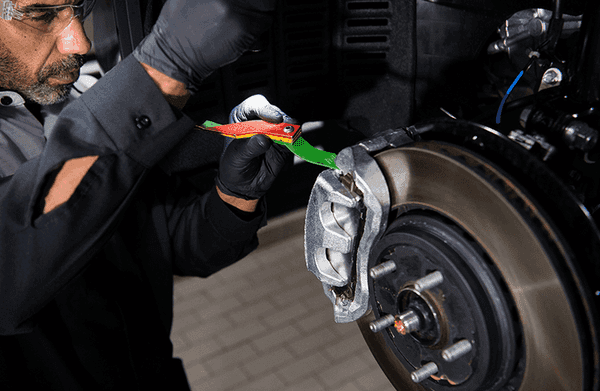 Lexus technician working on brakes