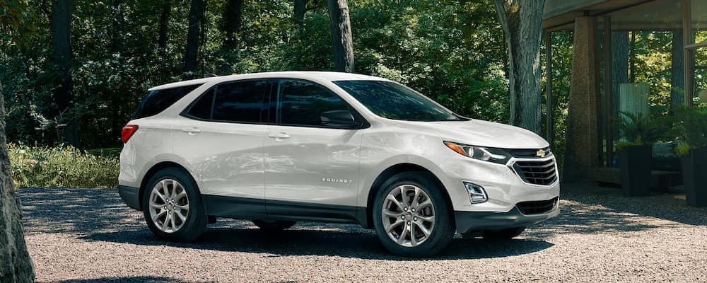 A white 2020 Chevy Equinox Parked on a Gravel Driveway